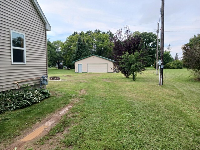 view of yard with an outbuilding and a garage