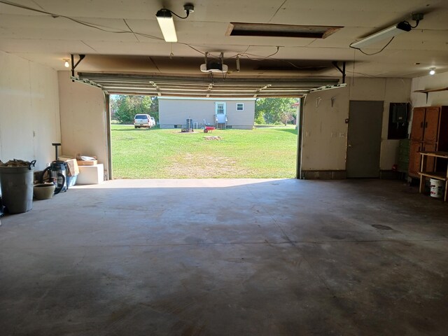 garage featuring electric panel and a garage door opener