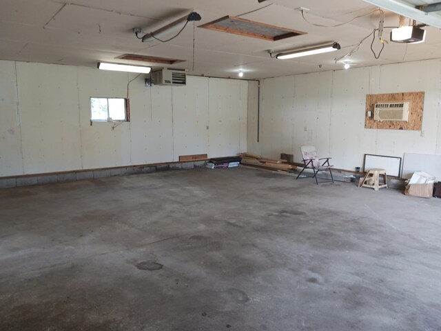 garage with an AC wall unit and a garage door opener