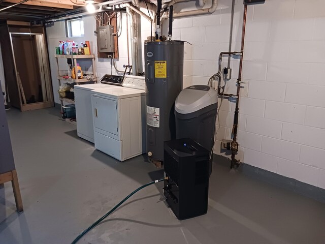 basement featuring electric panel, separate washer and dryer, and electric water heater