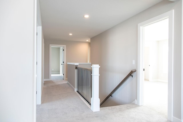 hallway featuring light colored carpet