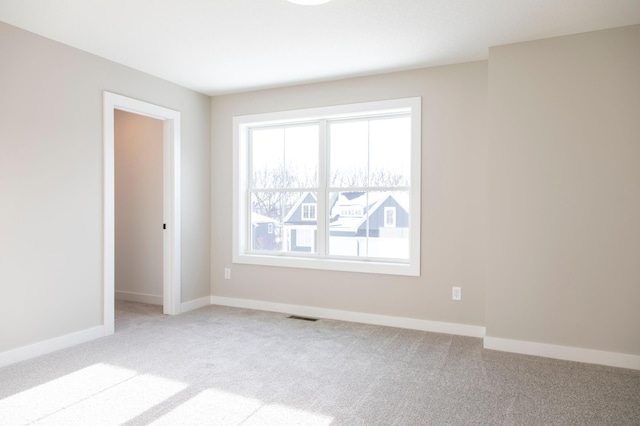 spare room with light colored carpet