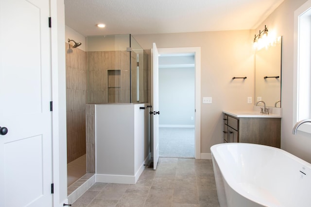 bathroom with vanity and shower with separate bathtub