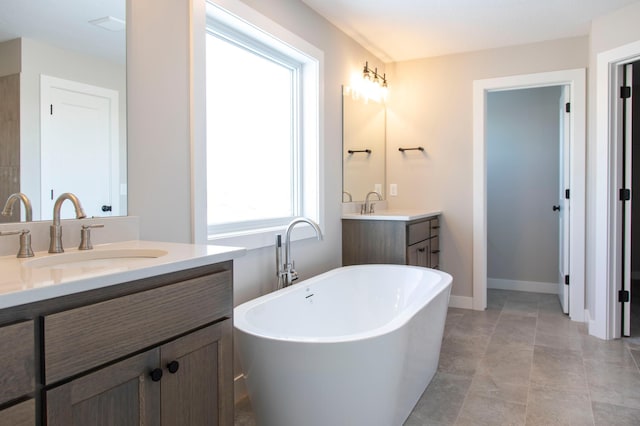 bathroom with vanity and a tub to relax in