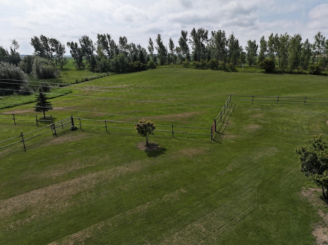 view of community with a lawn and a rural view