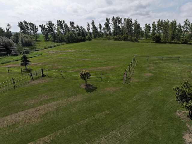 view of yard featuring a rural view and fence