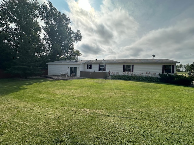 rear view of house featuring a lawn