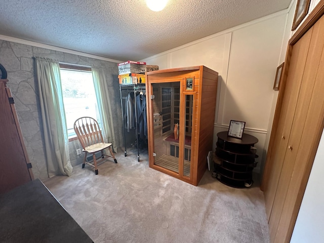 carpeted bedroom featuring a textured ceiling and ornamental molding