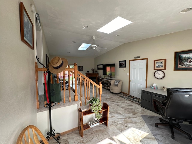 interior space featuring ceiling fan and vaulted ceiling with skylight