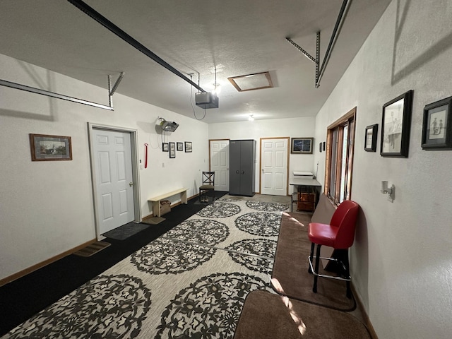 garage with baseboards and a garage door opener