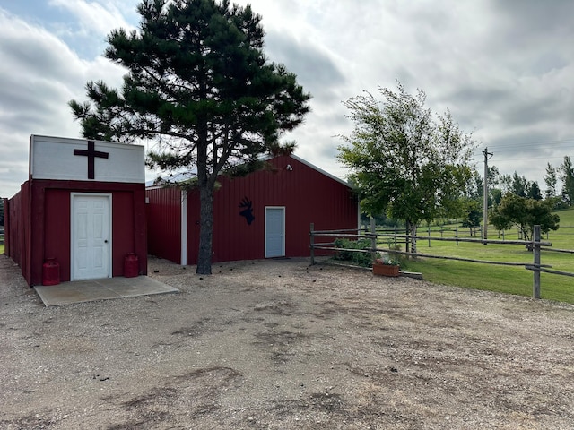 view of pole building featuring fence