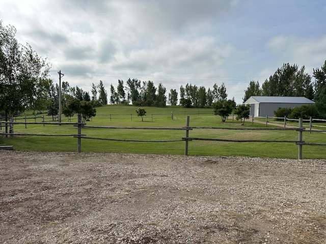 exterior space featuring a lawn and a rural view