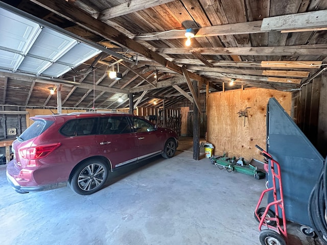 garage with wooden walls and a garage door opener