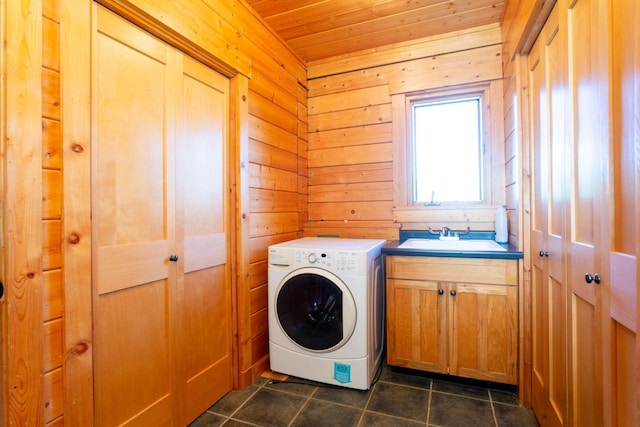 laundry room featuring a sink, washer / clothes dryer, cabinet space, dark tile patterned floors, and wood ceiling