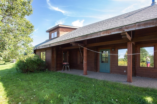 rear view of house with a yard and a patio