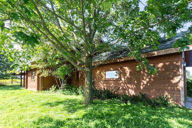 view of side of home with a lawn