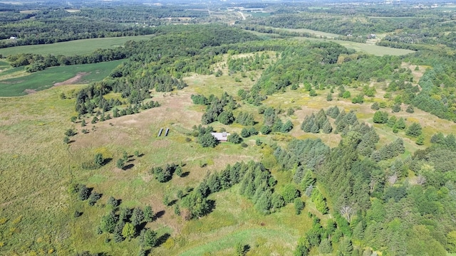 bird's eye view with a wooded view