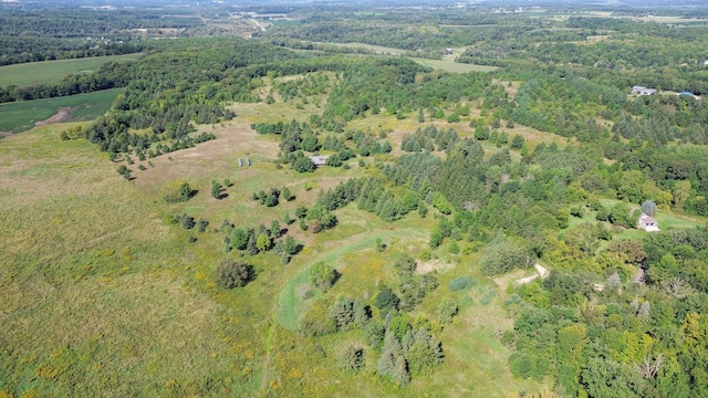 drone / aerial view with a wooded view