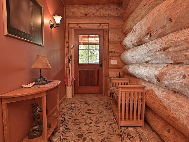 entryway with log walls and light colored carpet