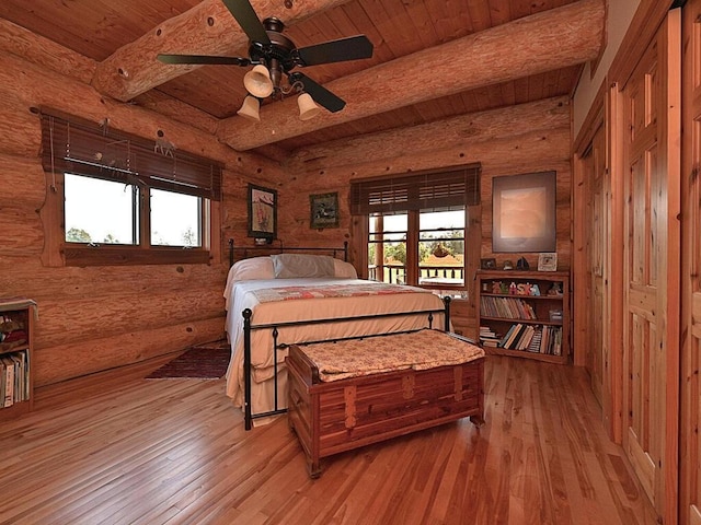 bedroom featuring wood ceiling, light hardwood / wood-style floors, beamed ceiling, and ceiling fan