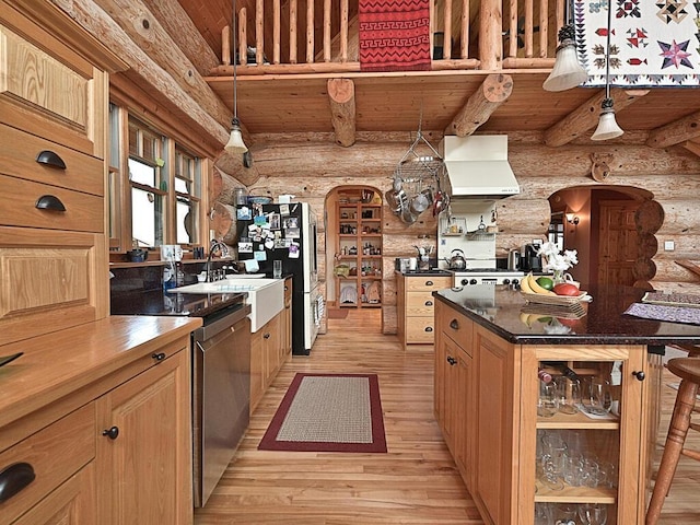 kitchen with hanging light fixtures, light hardwood / wood-style floors, and log walls