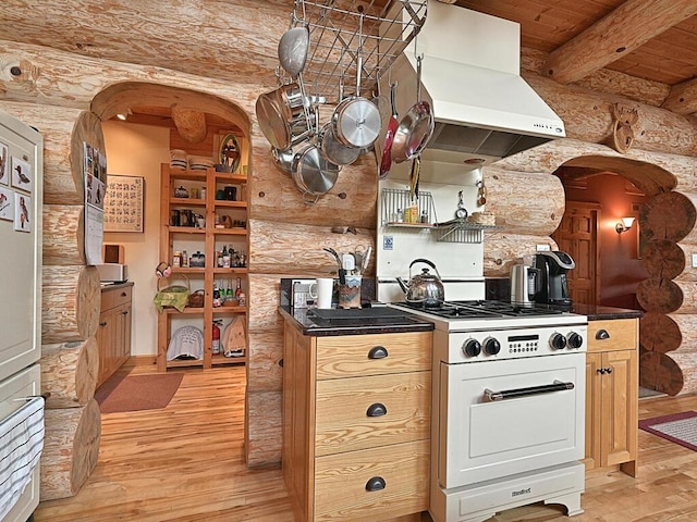 kitchen with light wood-type flooring, island range hood, gas range, and beam ceiling