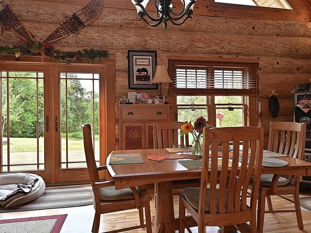 dining space featuring french doors, hardwood / wood-style flooring, and rustic walls