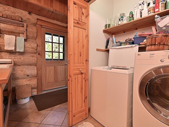 laundry area with light tile patterned floors and independent washer and dryer