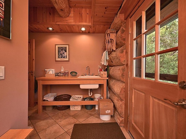 bathroom featuring tile patterned floors, sink, and wooden ceiling