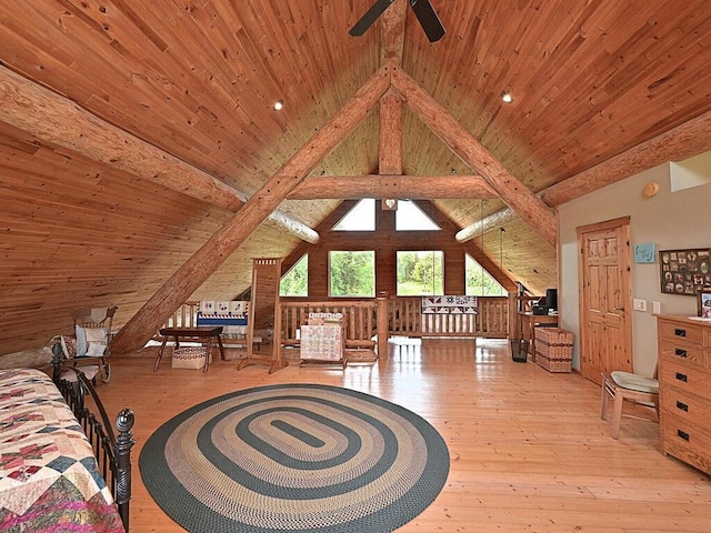 bedroom with light hardwood / wood-style floors, beamed ceiling, and wooden ceiling