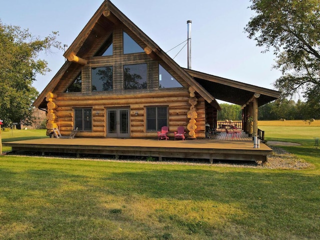 rear view of house with a deck and a lawn