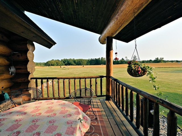 deck with a lawn and a rural view