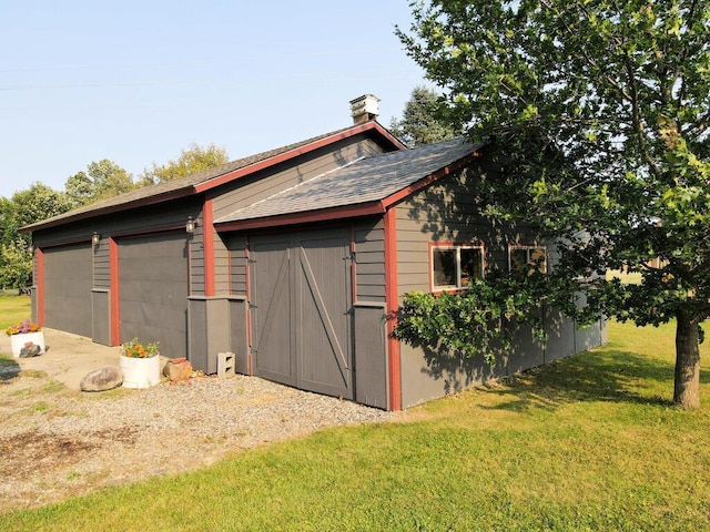 view of outbuilding featuring a lawn