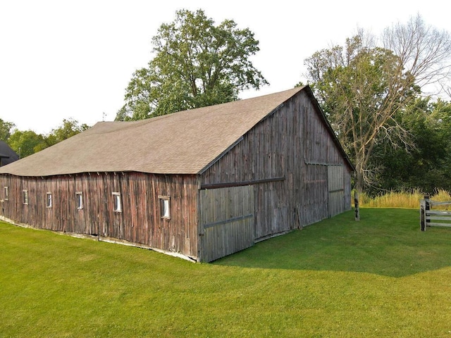 view of outbuilding featuring a lawn