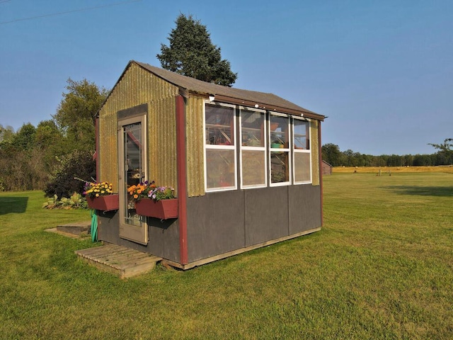 view of outbuilding with a yard