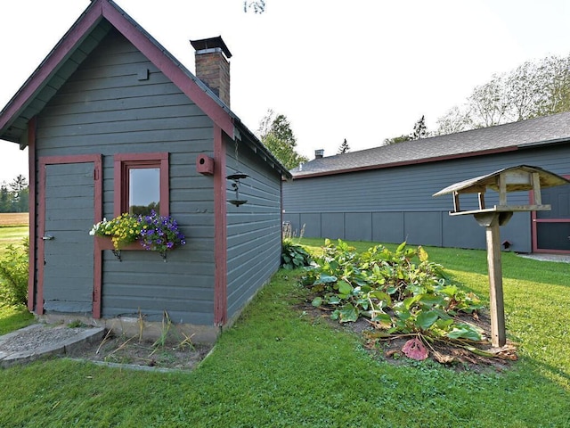 view of outdoor structure with a lawn