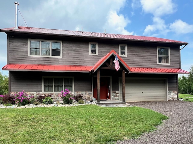 view of front of home featuring aphalt driveway, metal roof, a garage, stone siding, and a front lawn