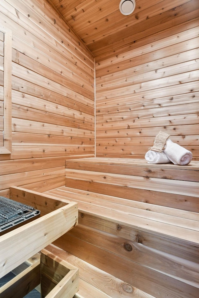 sauna featuring wood walls and wooden ceiling
