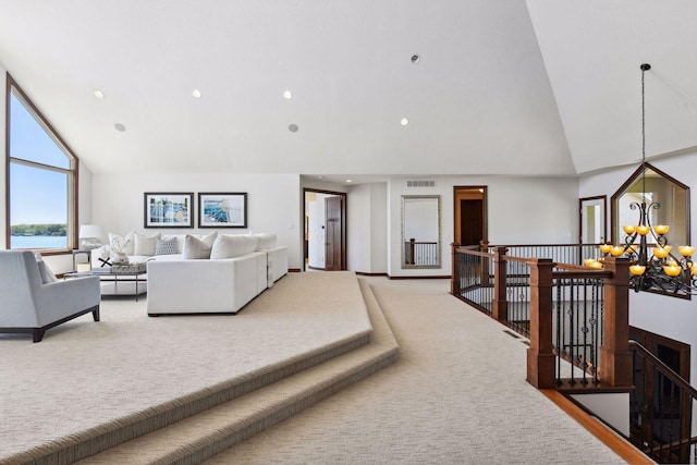 carpeted living room featuring high vaulted ceiling, a chandelier, and recessed lighting