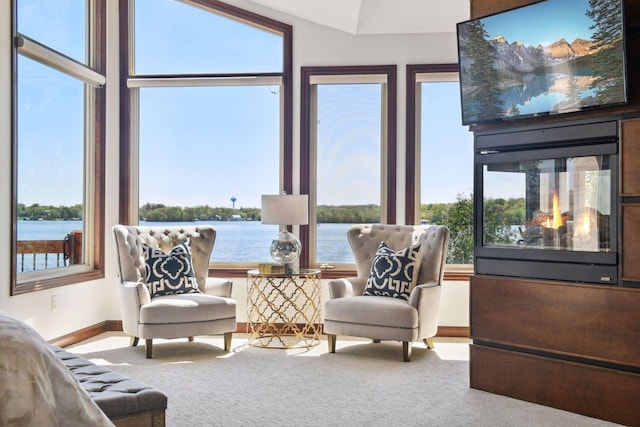 sunroom / solarium featuring a water view