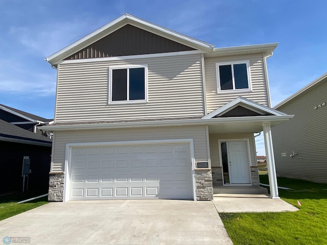 view of front of property with an attached garage, stone siding, and driveway