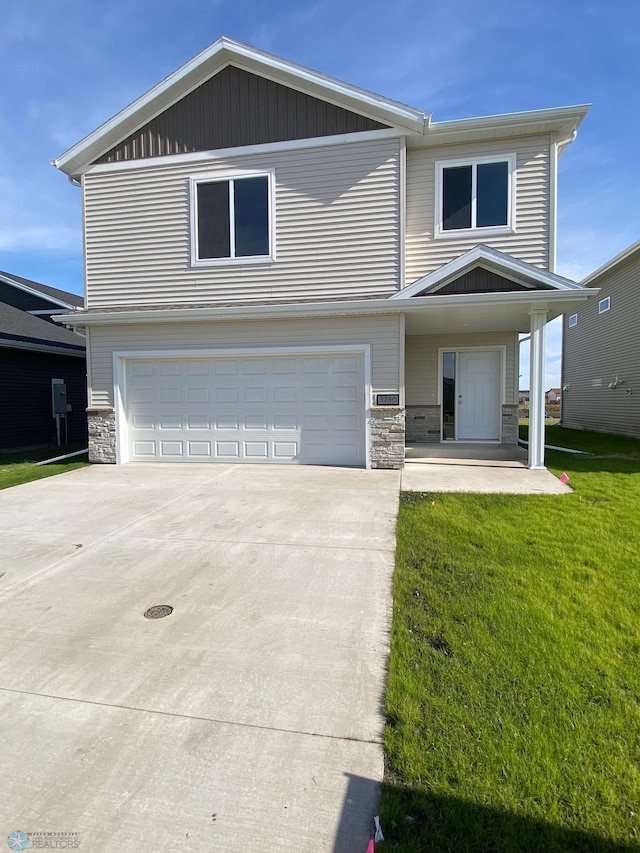 view of front of house featuring stone siding, concrete driveway, and a garage