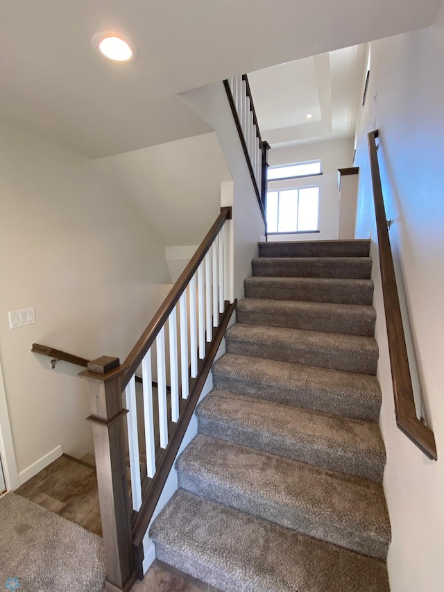 staircase featuring baseboards and recessed lighting