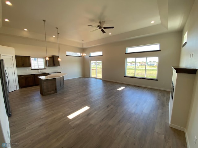 unfurnished living room featuring baseboards, dark wood-style floors, recessed lighting, and ceiling fan