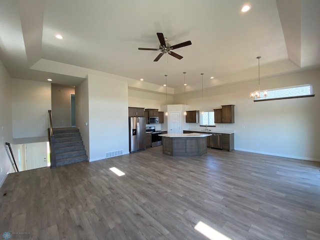 kitchen with open floor plan, appliances with stainless steel finishes, visible vents, and a kitchen island