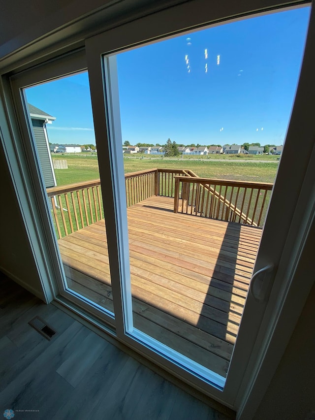doorway featuring wood finished floors and visible vents