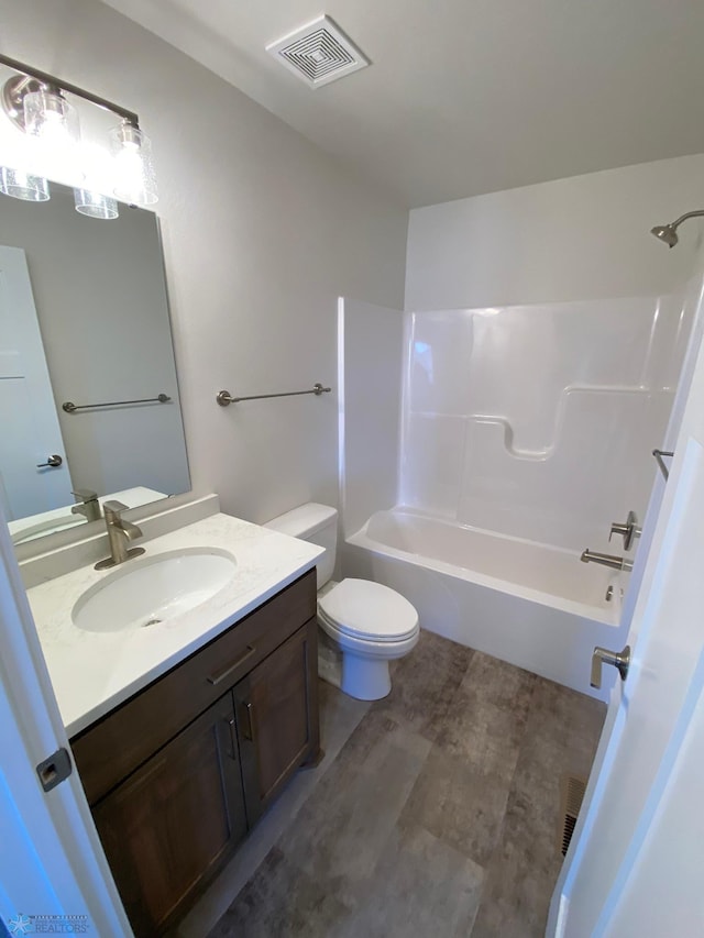 full bathroom with visible vents, vanity,  shower combination, and toilet