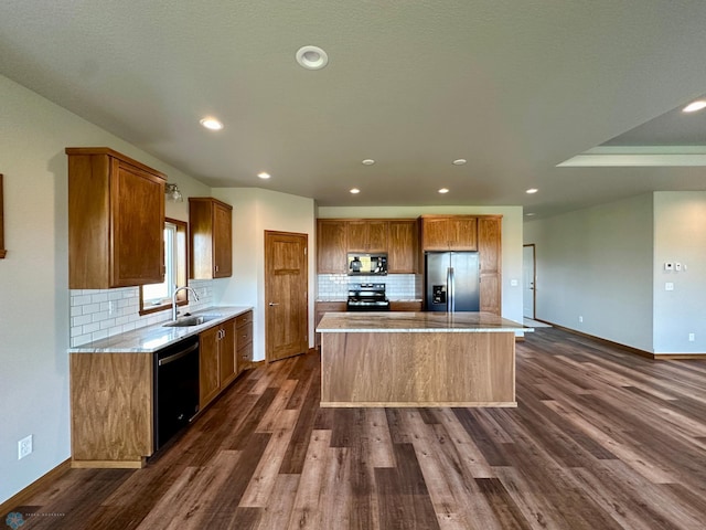 kitchen featuring black appliances, a center island, decorative backsplash, sink, and dark hardwood / wood-style floors