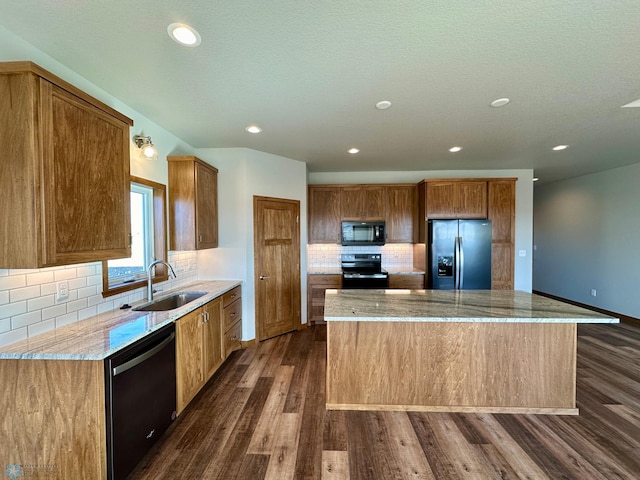 kitchen with black appliances, light stone counters, dark hardwood / wood-style flooring, and sink