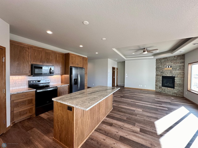 kitchen with stainless steel fridge, electric range oven, ceiling fan, and dark hardwood / wood-style floors